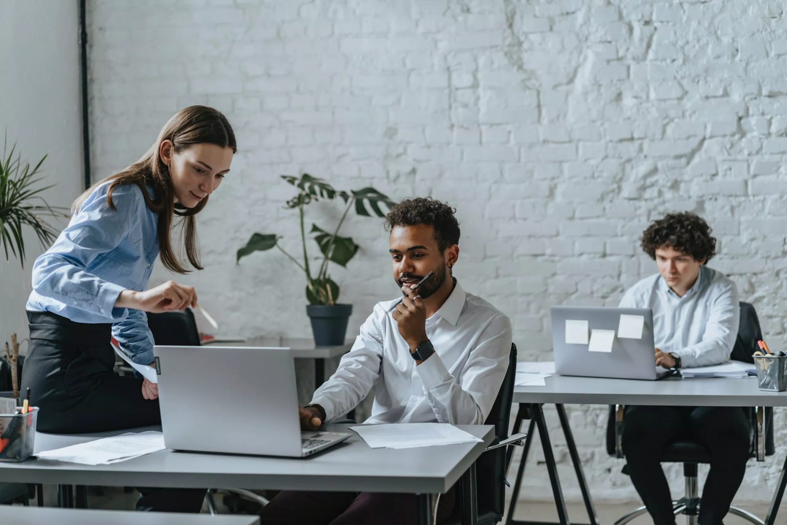 Image of a woman talking to a man in a work setting to showcase automation testing.