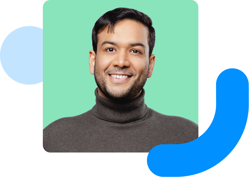 Image shows a smiling man with a green background. 